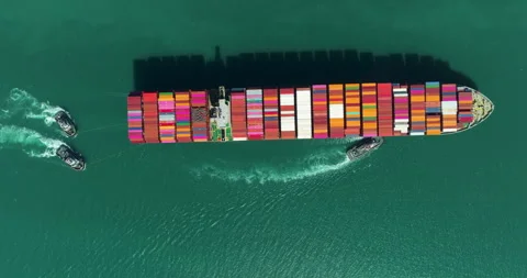 Large Container Ship Navigating Coastal Waters Assisted By Tugboats Aerial Sh Stock Footage 340131128