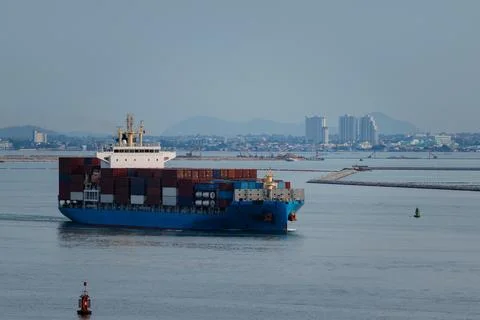 Large Container Ship Navigating Coastal Waters Toward City Harbor Side Prof.. Stock Photos