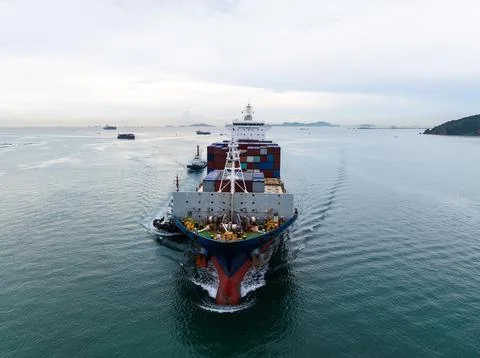 Large Container Ship Navigating Coastal Waters With Tugboat Assistance High.. Photos