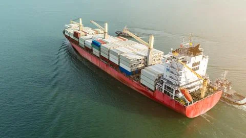 Large Container Ship Navigating Coastal Waters Assisted By Tugboats High An.. 库存照片