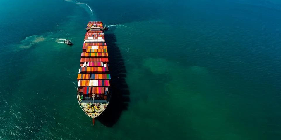 Large Container Ship Navigating Coastal Waters With Tugboat Assistance High.. Stock Photos