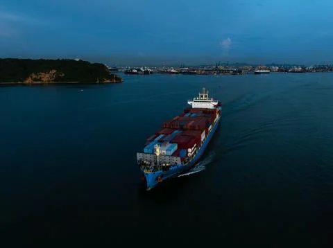 Large Container Ship Navigating Coastal Waters Near Si Racha Thailand At Dusk Stock Photos