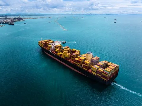 Large Container Ship Navigating Coastal Waters Toward Port Terminal High An.. Stock Photos