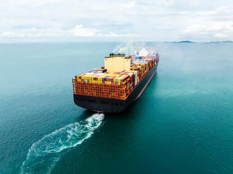 Large Container Ship Navigating Through Open Sea High Angle Shot Фото