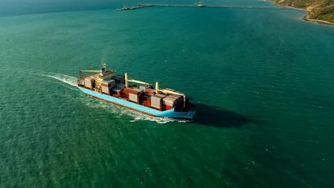 Large Container Ship Navigating Through Turquoise Coastal Waters Near Srira.. Photos
