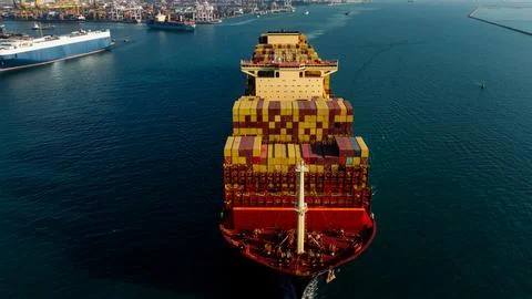 Large Container Ship Navigating Through Busy Industrial Harbor Of Laem Chab.. Stock Photos