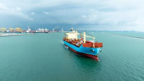 Large Container Ship Navigating Toward Industrial Port Harbor Aerial View Stock Photos