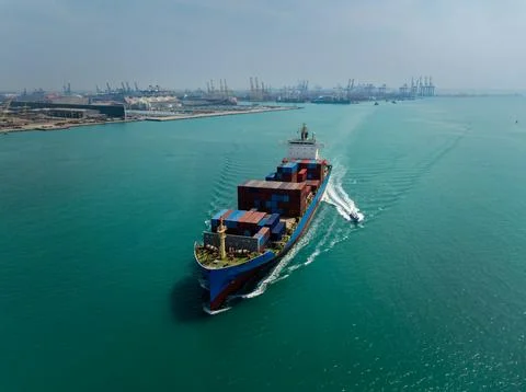 Large Container Ship Navigating Toward Industrial Port Terminal In Thailand.. Stock Photos