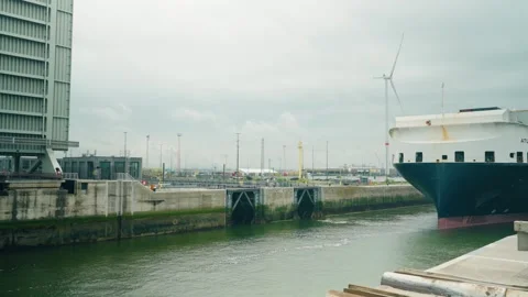 Large container ship passing Kieldrechtsluis lock in Antwerp port with raised Stock Footage 340935026
