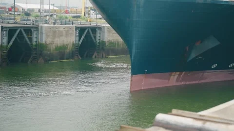 Large container ship passing Kieldrechtsluis lock in Antwerp port with raised Stock Footage 340935083