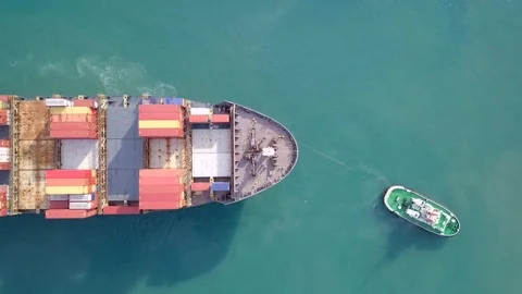 Large container ship pulled into port by tugboats - Top down aerial footage Stock Footage 98096605