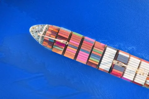 Large container ship sailing blue sea. Top aerial view Stock Photos