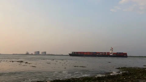 Large container ship sailing past a petroleum base in Cochin, Kerala, India Stock Footage 341608648