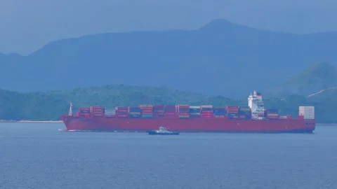 Large Container Ship sailing in still waters in the morning under blue sky. 스톡 동영상 133388501