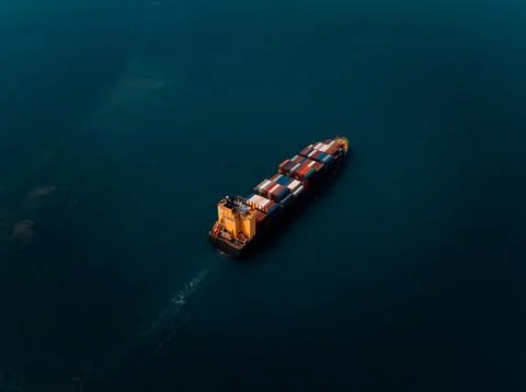 Large Container Ship Sailing Through Deep Blue Ocean Waters Near Si Racha C.. Stock Photos