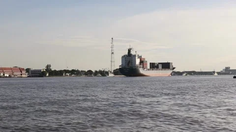 Large container ship at sea departing from wharf harbor port discharge cargo Stock Footage 336446172