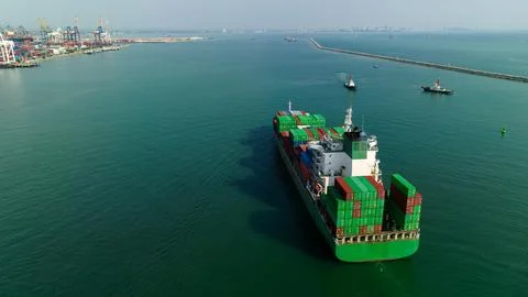 Large Container Ship Transiting Busy Commercial Harbor In Thailand Wide Shot 库存照片