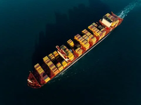 Large Container Ship Transporting Cargo Containers Across Open Sea In Si Ra.. Stock Photos