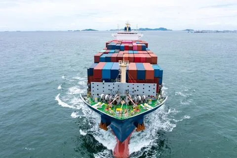 Large Container Ship Transporting Freight Cargo Across The Ocean Near Chonb.. Stock Photos