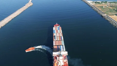 Large Container Ship With Tug Boat in Port Area, Aerial View Video stock 91128437