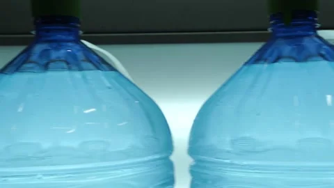 Large containers are going to be seen on the line for the purity of the water Stock Footage 162974996