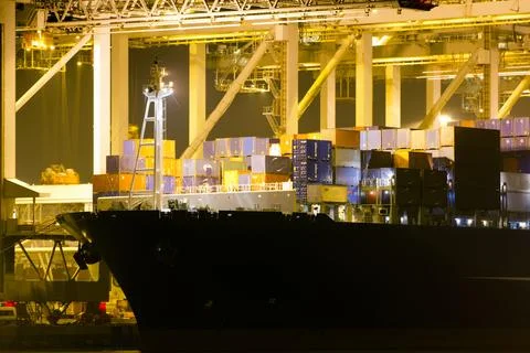 A large containership in a harbour Stock Photos