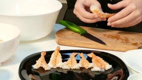 Large cooked shrimp spread on a black plate Stock-Footage 72336849