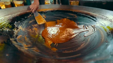 In a large copper bowl brewed coconut sugar. nice color natural product. Asian Video stock 72904491