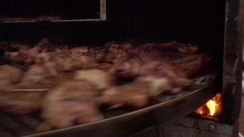 Large couscous meat quickly twirls on a round grill in a street food Stock Footage 139229613