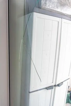 Large crack across a triple glazed window in a residential apartment. Indicates Stock Photos