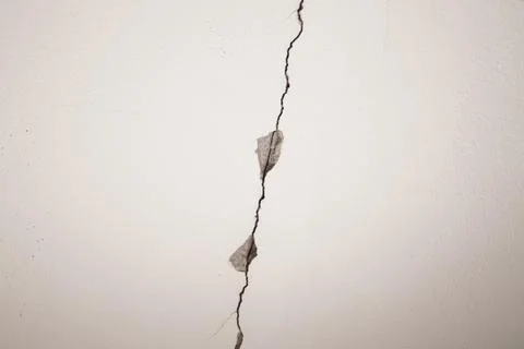 Large crack on white ceiling. Stock Photos