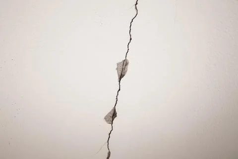 Large crack on white ceiling. Stock Photos