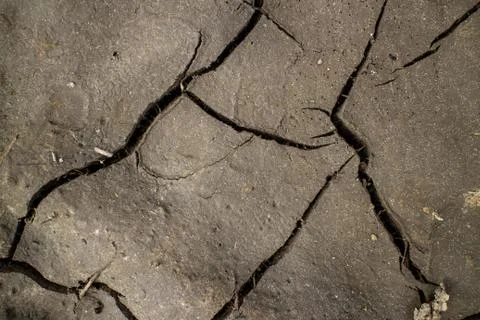 Large cracks in the ground. Abstract lines. Beautiful background. Nature. Stock Photos