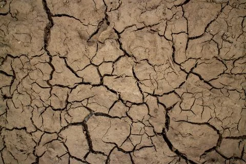 Large cracks in the ground. Abstract lines. Beautiful background. Nature. Stock Photos