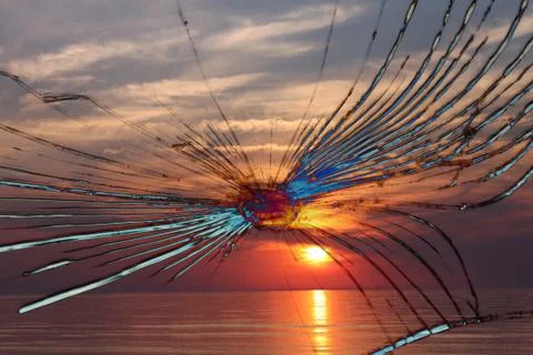 Large cracks on the texture of a broken mirror, glass on a bright red backgro Stock-Fotos