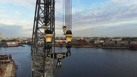 Large crane and hooks with a cargo port in the background. Multi-ton crane hooks 스톡 동영상 154301679