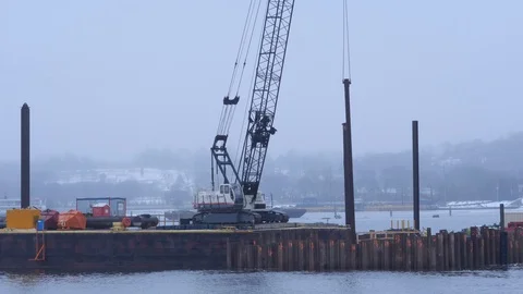 Large Crane on Bardge Moving Support Beams to Build Bridge Stockbeeldmateriaal 104890271