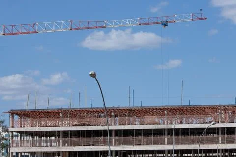 A Large crane being used for the construction of a new apartment building Stock Photos