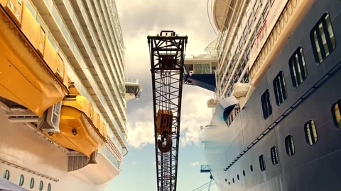 Large crane between two cruise ships docked side by side Stock Footage 256797592