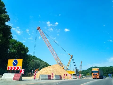 Large crane during the construction of the road. Stock Photos