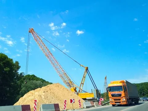 Large crane during the construction of the road. Stock Photos