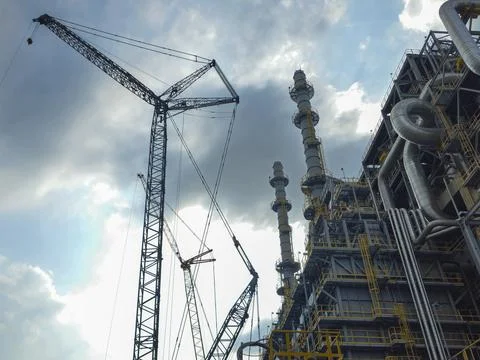 A large crane is lifting a heavy object Stock Photos