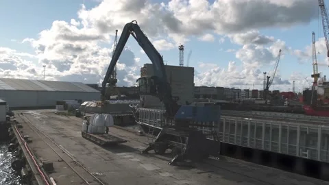 Large crane loads cargo steamboat with mineral fertilisers Stock Footage 146718607