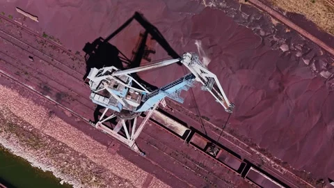 Large crane moves material at a loading dock near a river Stock Footage 343125241