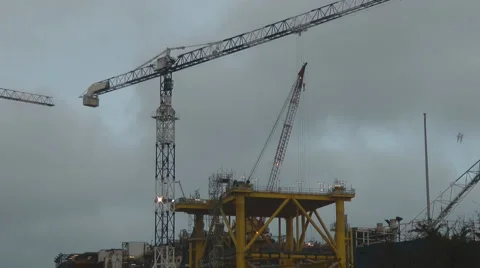 Large crane working in ship yard, construction of off shore oil platform. 動画素材 1090676