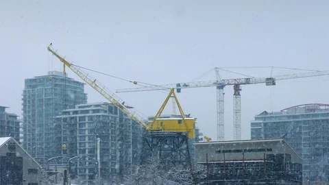 Large Cranes In City With Snow Falling Stock Footage 72988455
