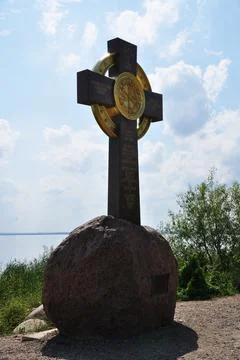 Large cross on a stone base. Cross on the shores of Lake Nero. Stock Photos