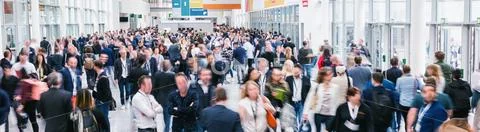 Large crowd of anonymous blurred people at a trade show Stock Photos