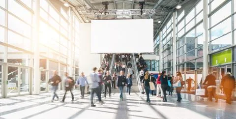 Large crowd of anonymous blurred people at a trade show, including copy space Stock Photos