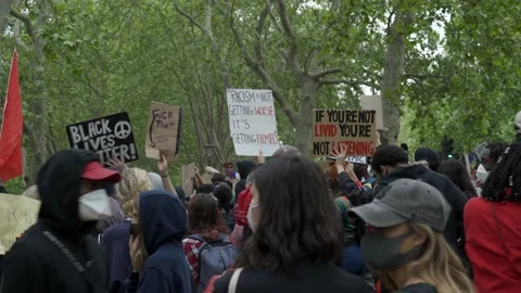 A large crowd of anti racism protesters with placards in London Stock Footage 131845199